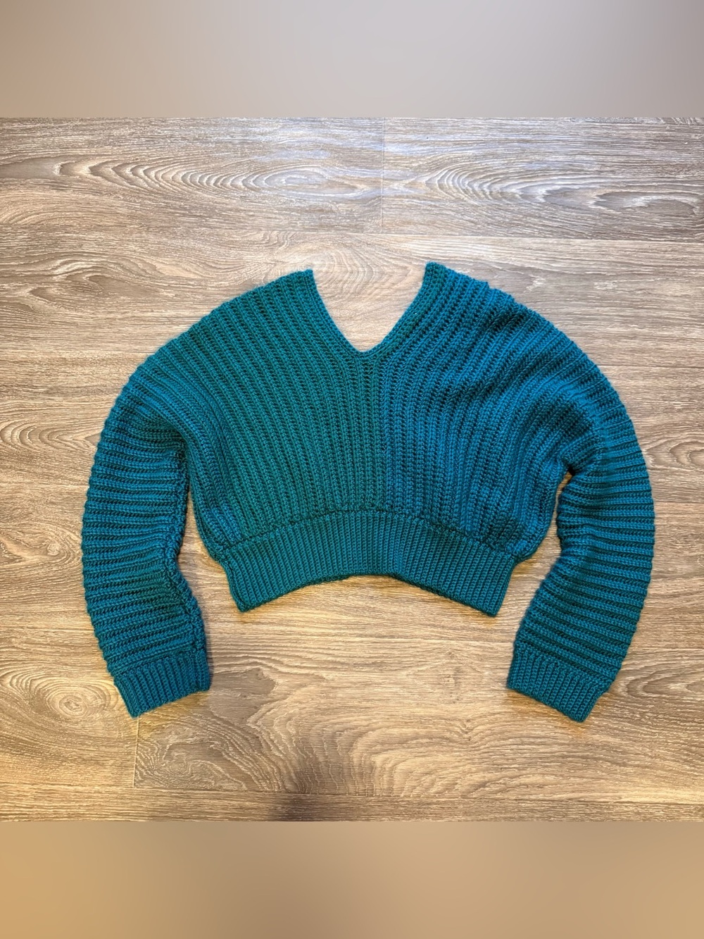 teal-colored ribbed chunky knit v-neck cropped sweater